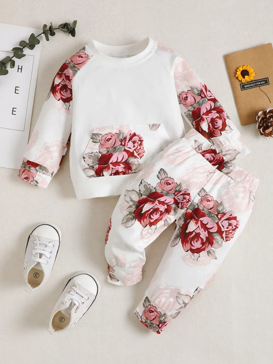 two-piece baby outfit with floral top and matching pant o soft white background