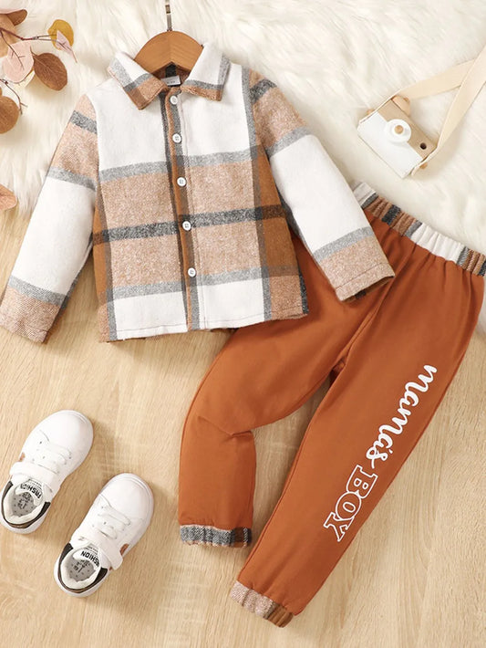 children's two-piece outfit with a button up color block top and matching pants displayed on flat neutral lighting